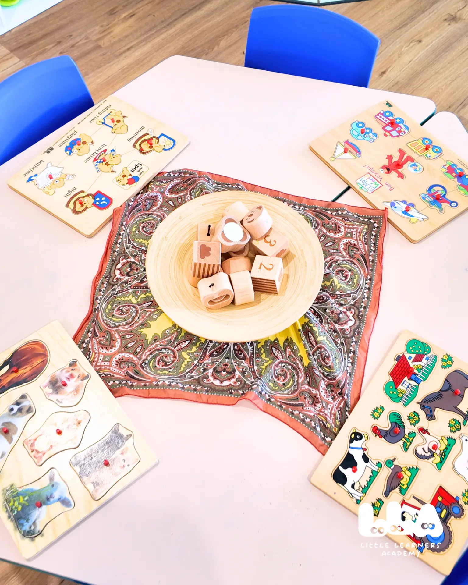 Wooden puzzles and learning blocks on a classroom table