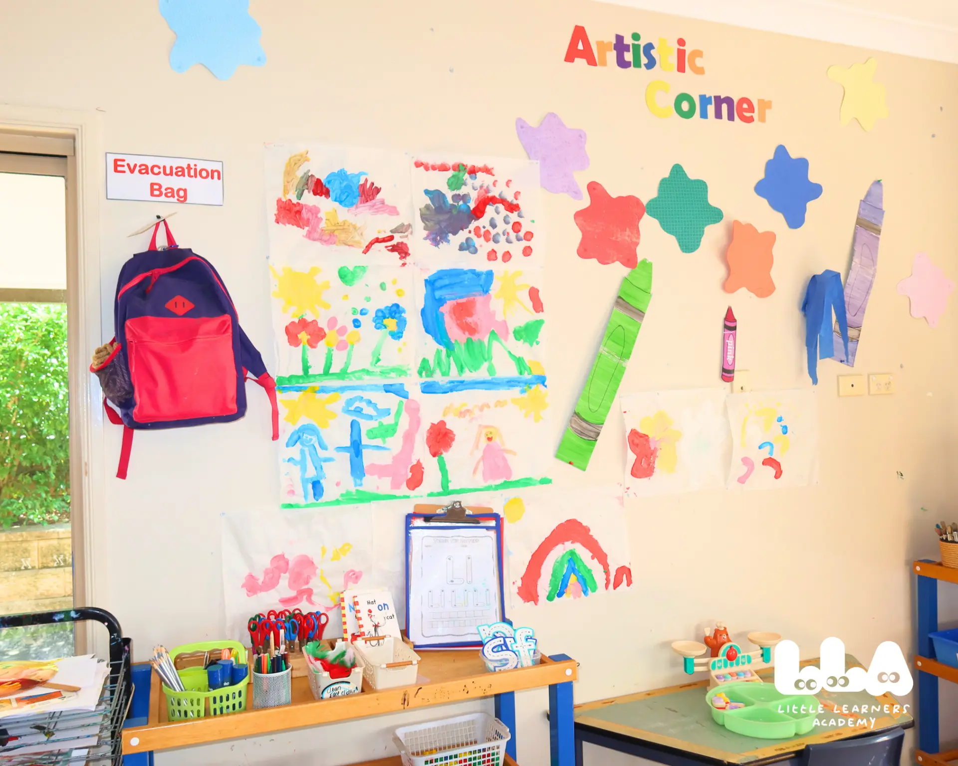 Artistic corner wall covered in children's paintings